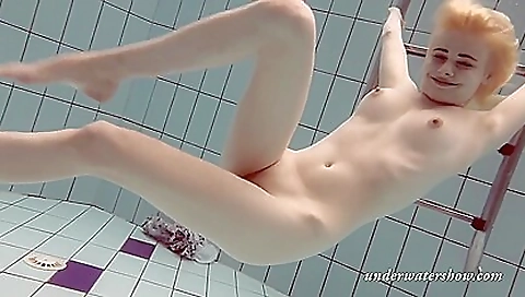 Hot blonde on the beach getting naked on the water