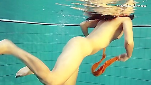 Stunning brunette with amazing figure in the water