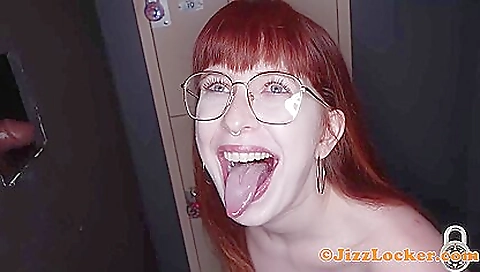 A redhead is giving a deepthroat and facial to a brunette